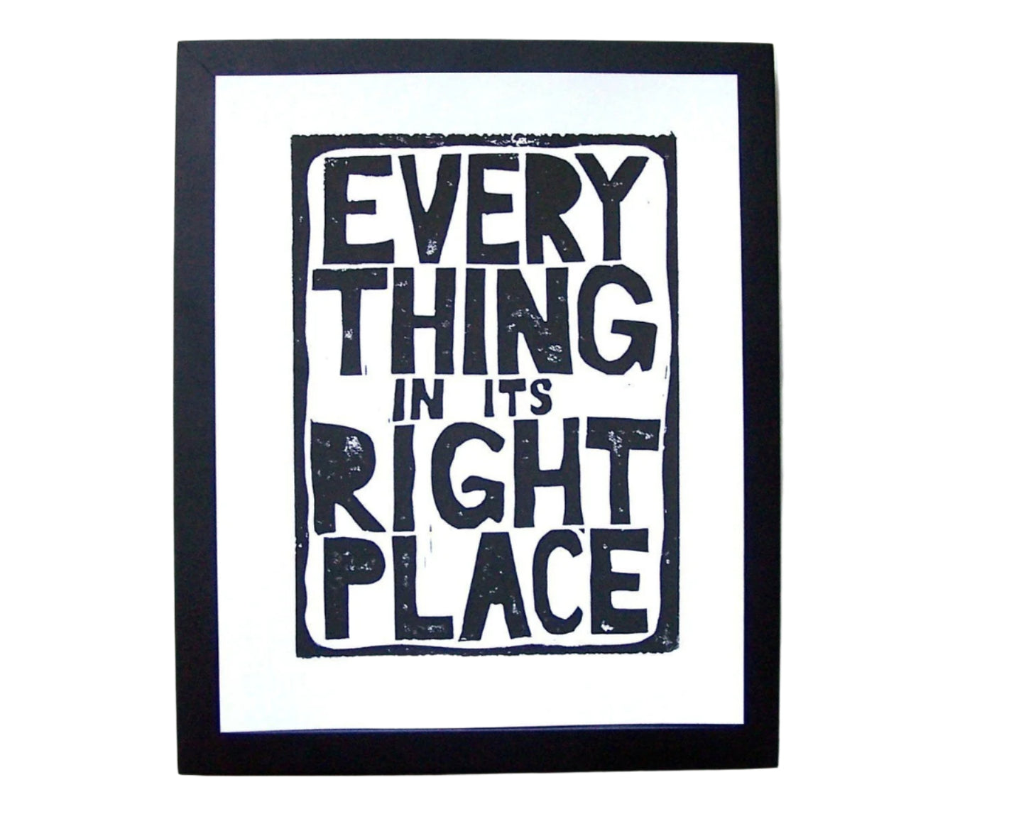 Framed artwork with text 'Everything in its right place' on a white background