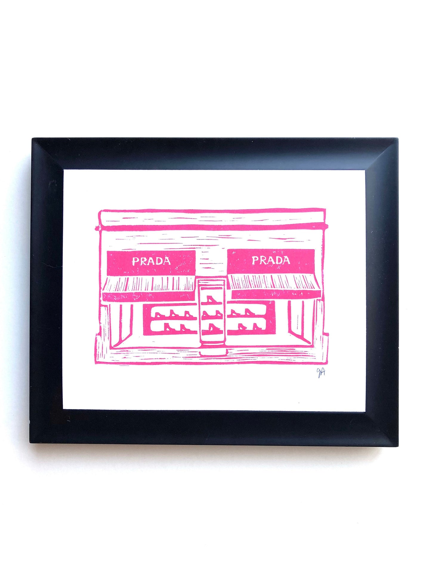 Framed artwork of a pink Prada store illustration on a white background