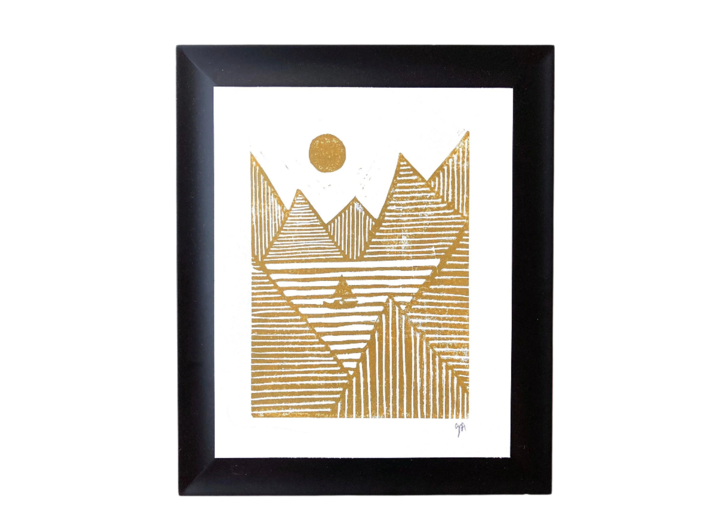 Framed artwork with gold geometric mountain design on a white background
