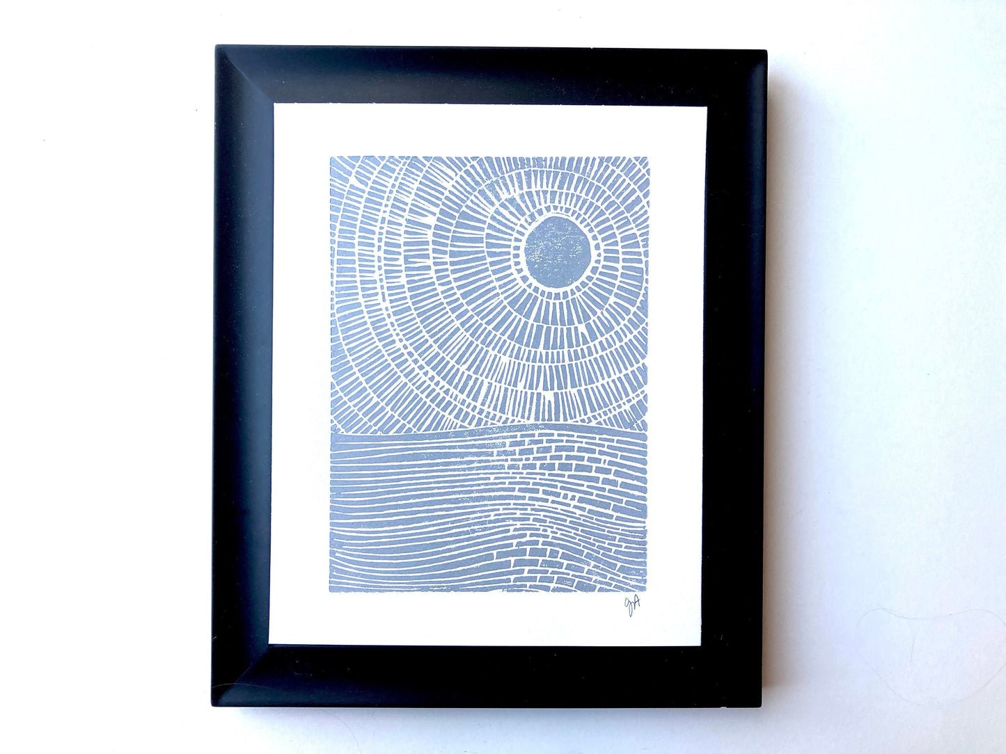 Framed abstract landscape ocean print with concentric circles on a white background