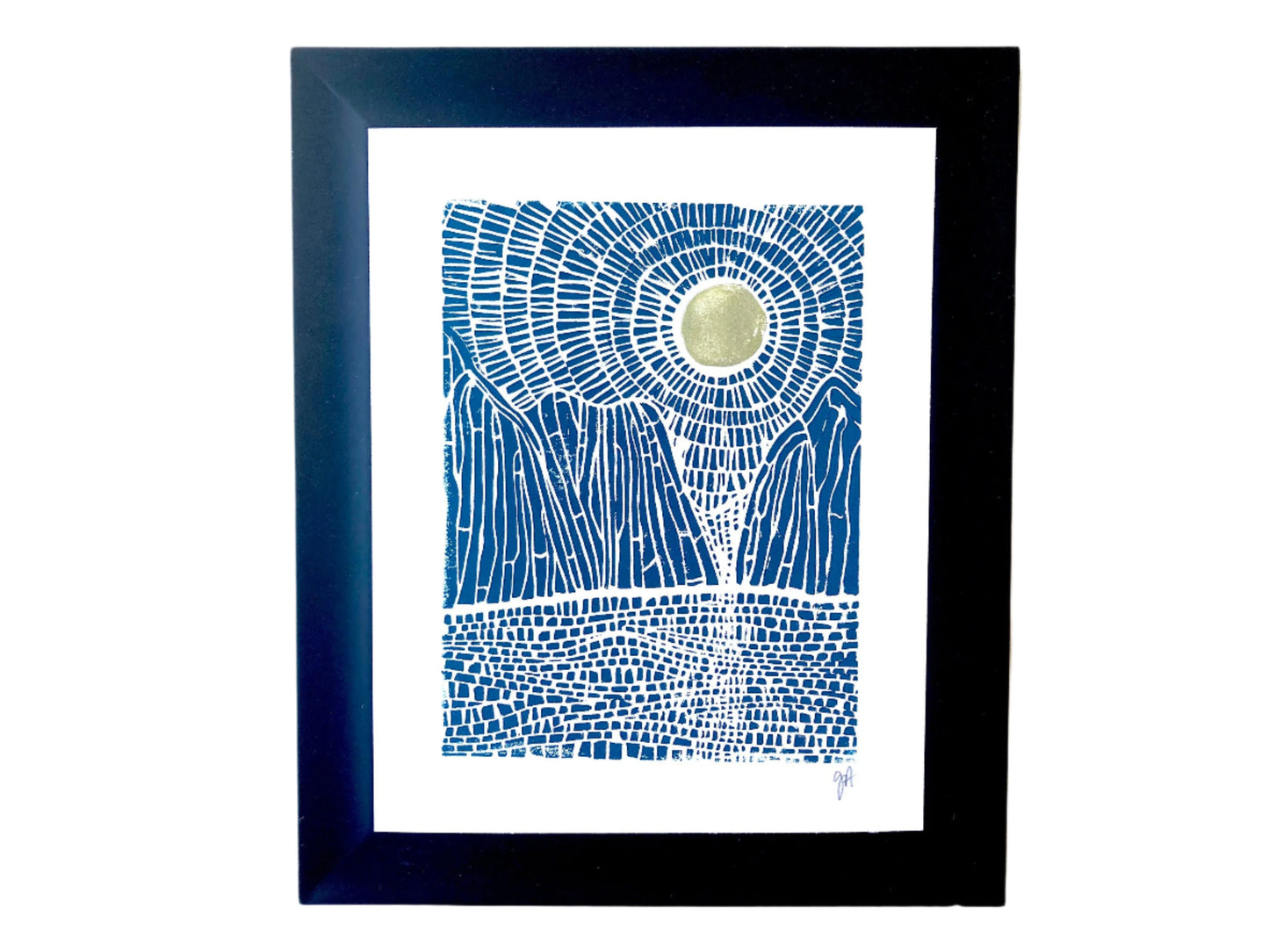 Framed artwork with blue abstract landscape of mountains, sun, and ocean