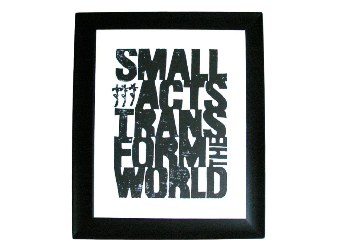 Framed linoleum block poster with motivational quote 'Small acts transform the world' by Howard Zinn in black linocut ink on a white background
