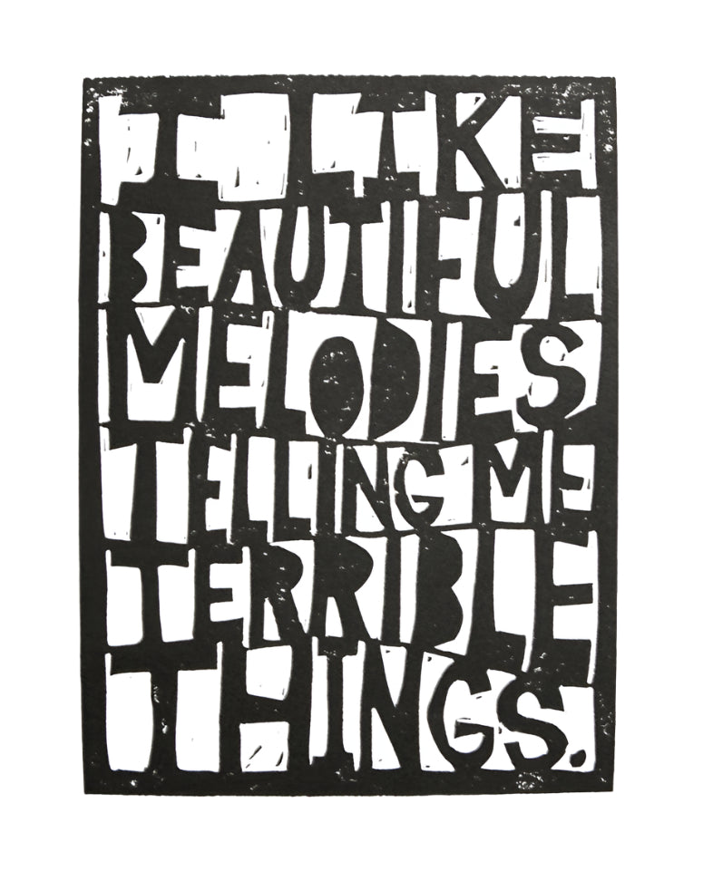 Black and white linocut print reading "I like beautiful melodies telling me terrible things" by Tom Waits and The Big Harumph