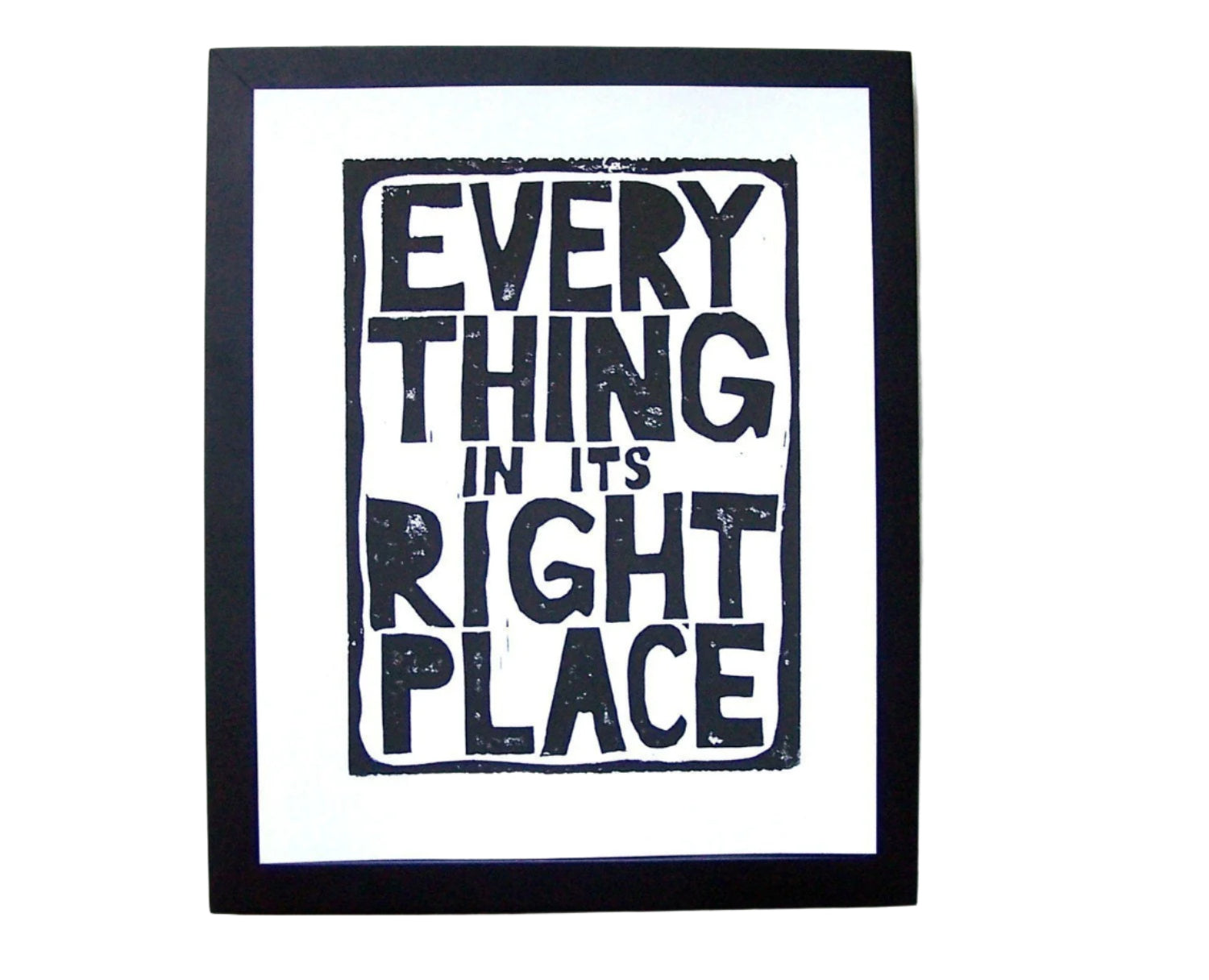 Framed artwork with text 'Everything in its right place' on a white background
