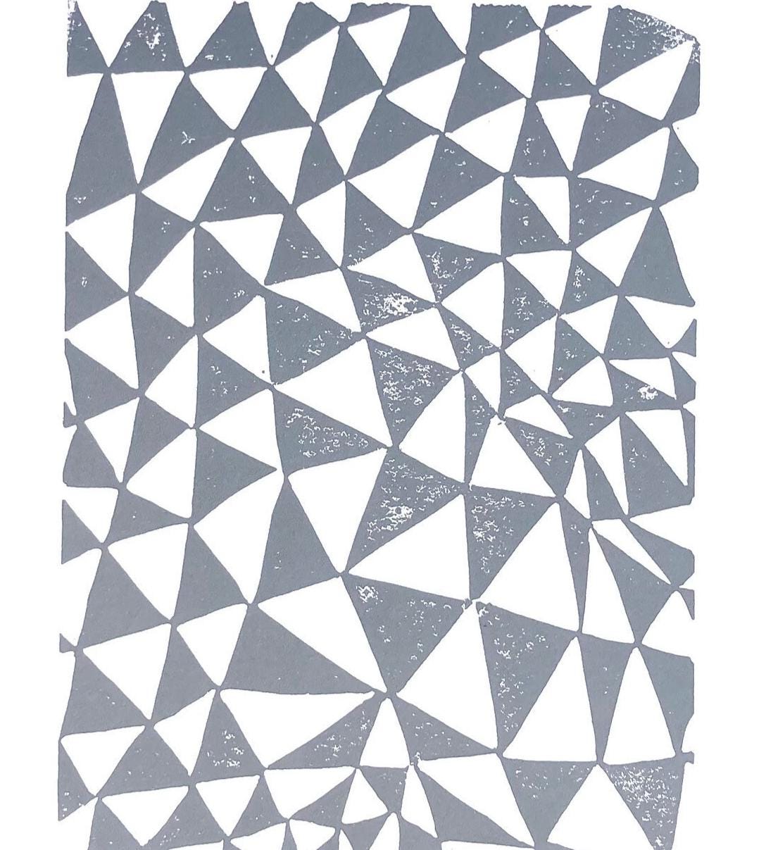 Geometric pattern with triangles in gray and white on a textured background