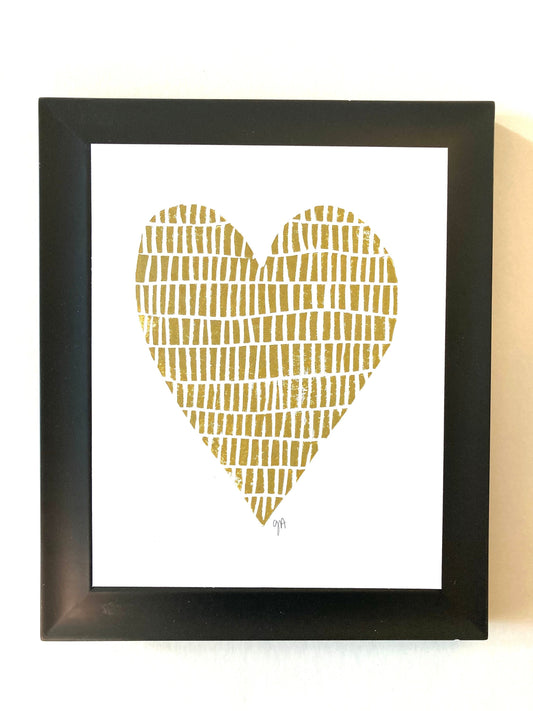 Framed artwork with a gold heart design on a white background