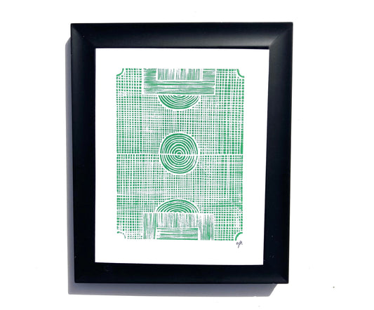 Framed artwork with green geometric pattern of a soccer field on a white background