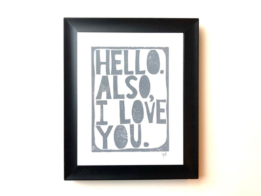 Framed print with 'Hello. Also, I love you.' text on a white background