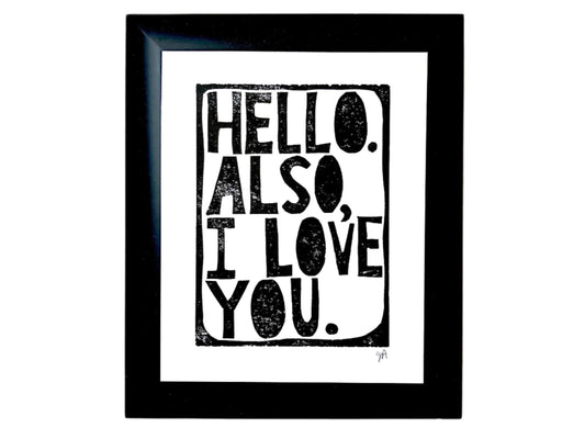 Framed linocut print with 'Hello. Also, I love you.' text on a white background