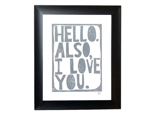 Framed print with 'Hello. Also, I love you.' text in grey on a white background