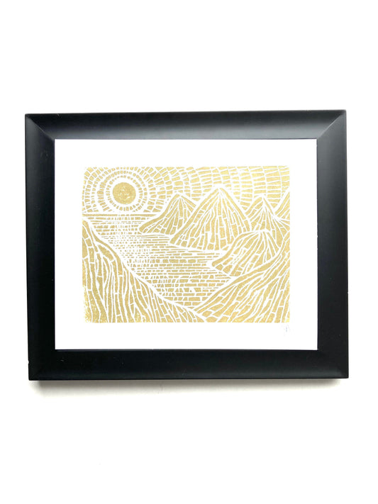 Framed artwork with gold islands design on white background