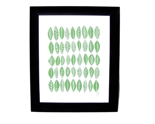 Framed artwork with green leaf pattern on a white background