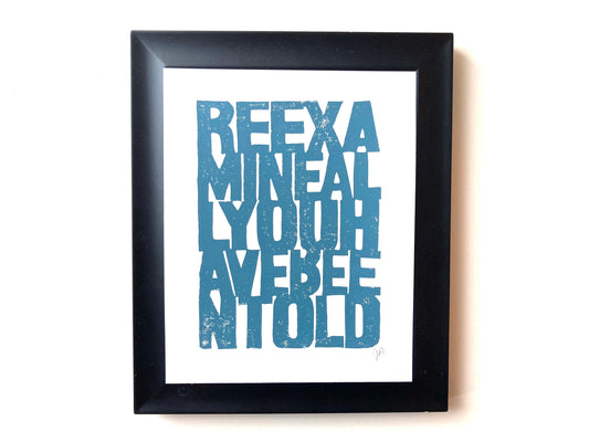 Framed artwork with blue Walt Whitman quote on a white background