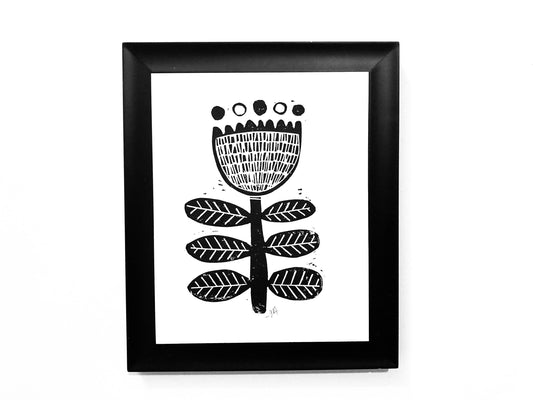 Framed black and white floral artwork on a white background