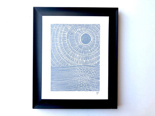Framed abstract landscape ocean print with concentric circles on a white background
