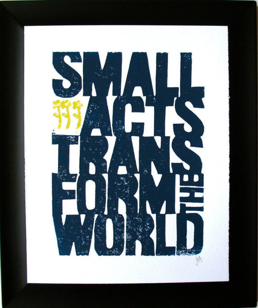Framed print with motivational quote 'Small acts transform the world' on a white background