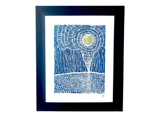 Framed artwork with blue abstract landscape of mountains, sun, and ocean