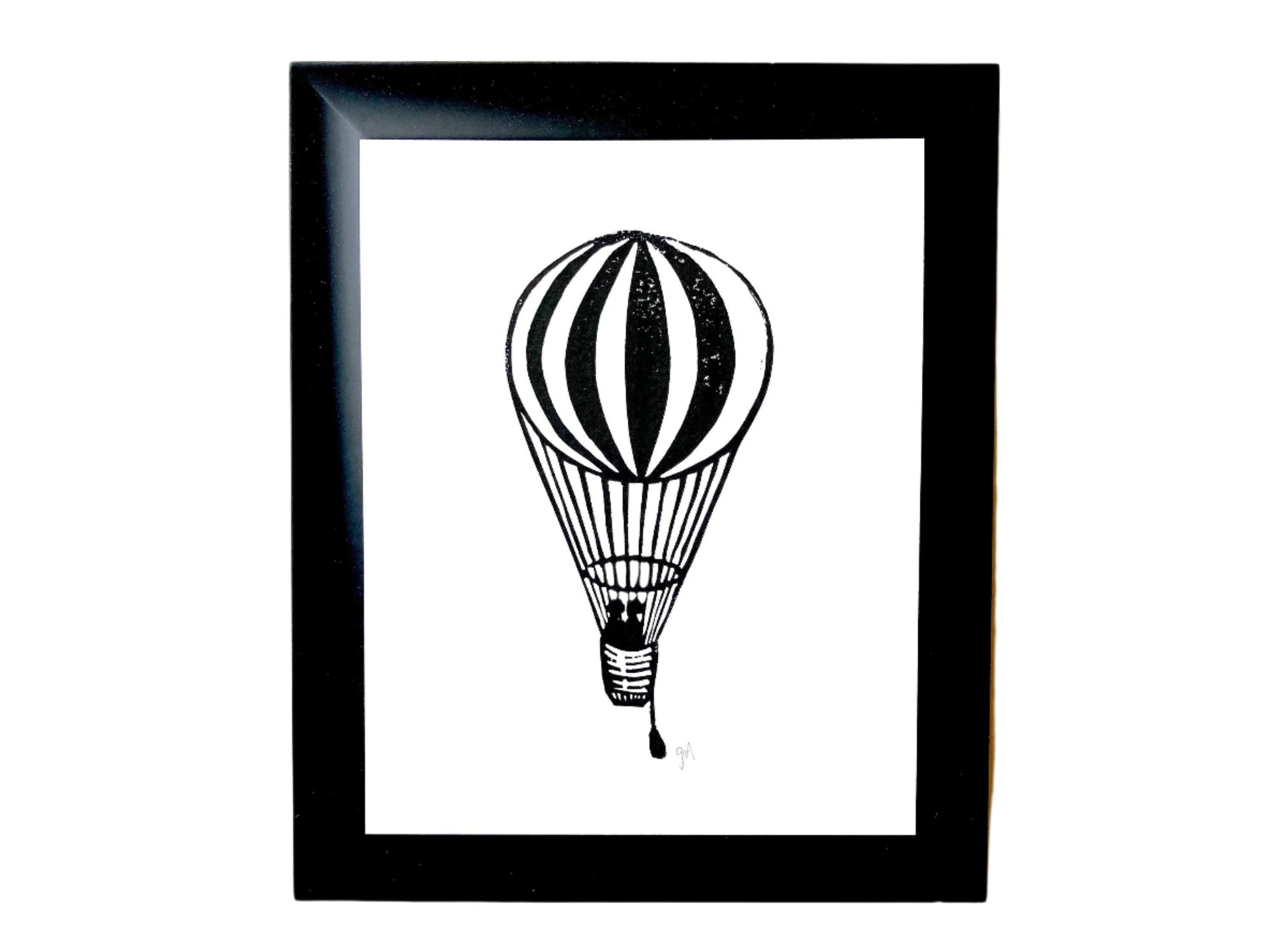 Framed original linoleum block print of a black hot air balloon, 8x10.