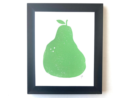 Framed artwork of a green pear on a white background